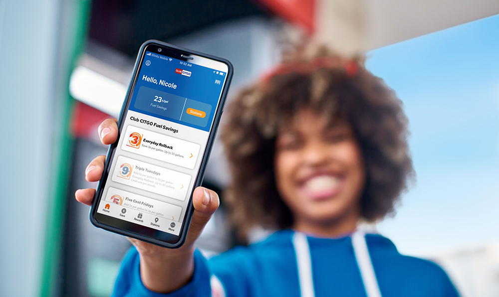 Girl holding phone with ClubCITGO app open