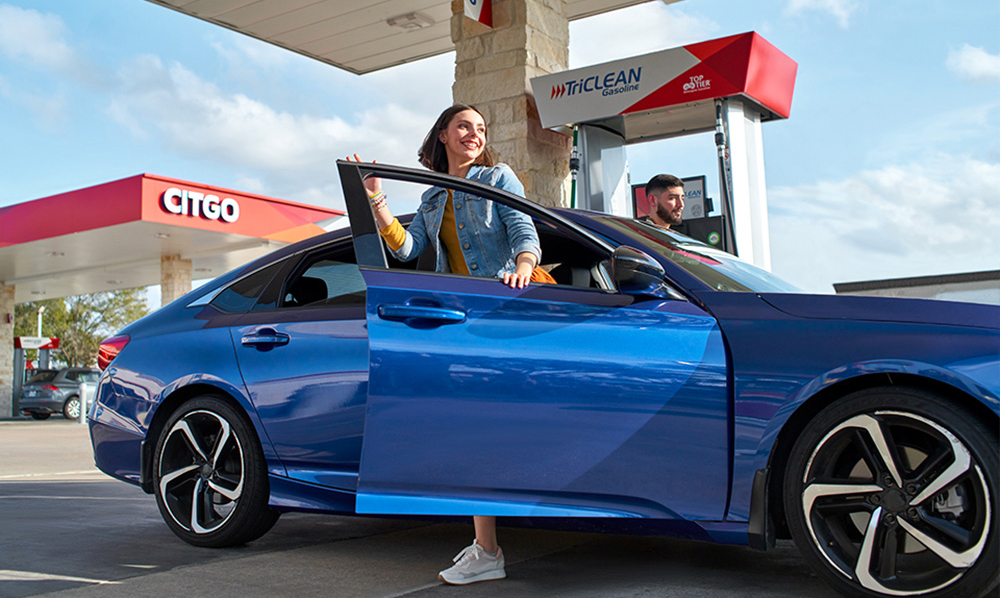 Girl getting out of car in front of CITGO station
